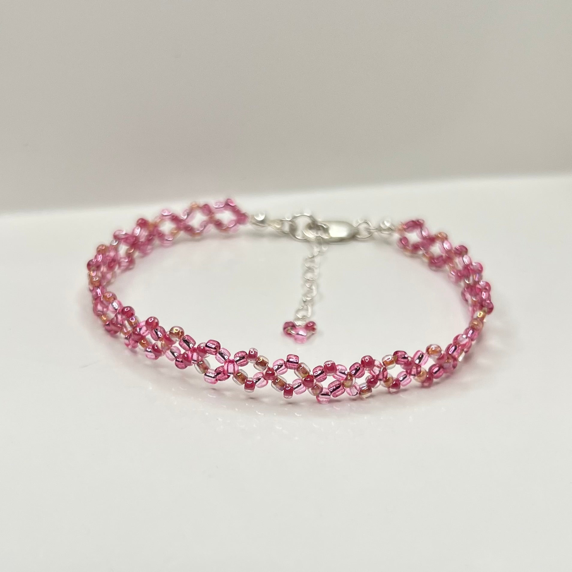 Pink beaded bracelet on a white background