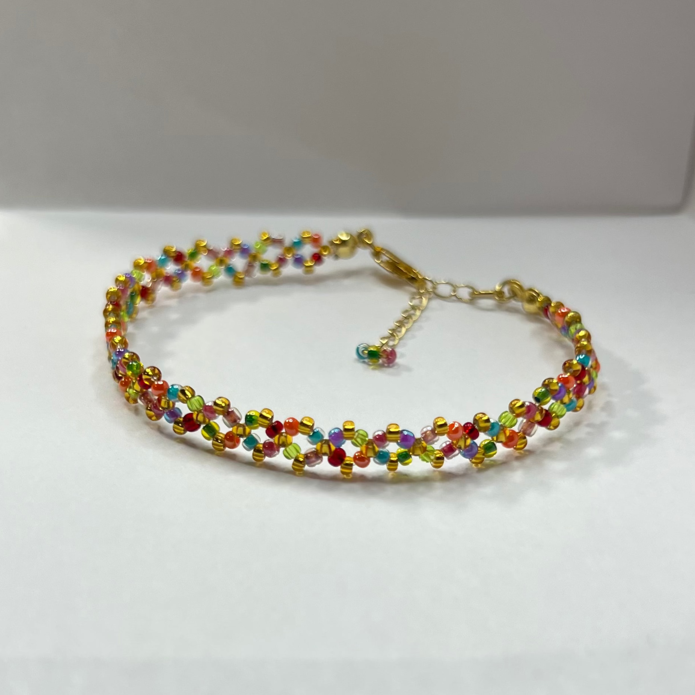 Multicolored beaded bracelet on a white surface