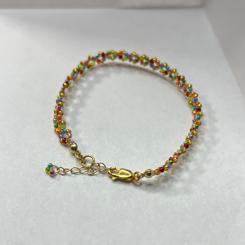Colorful beaded bracelet on a white surface