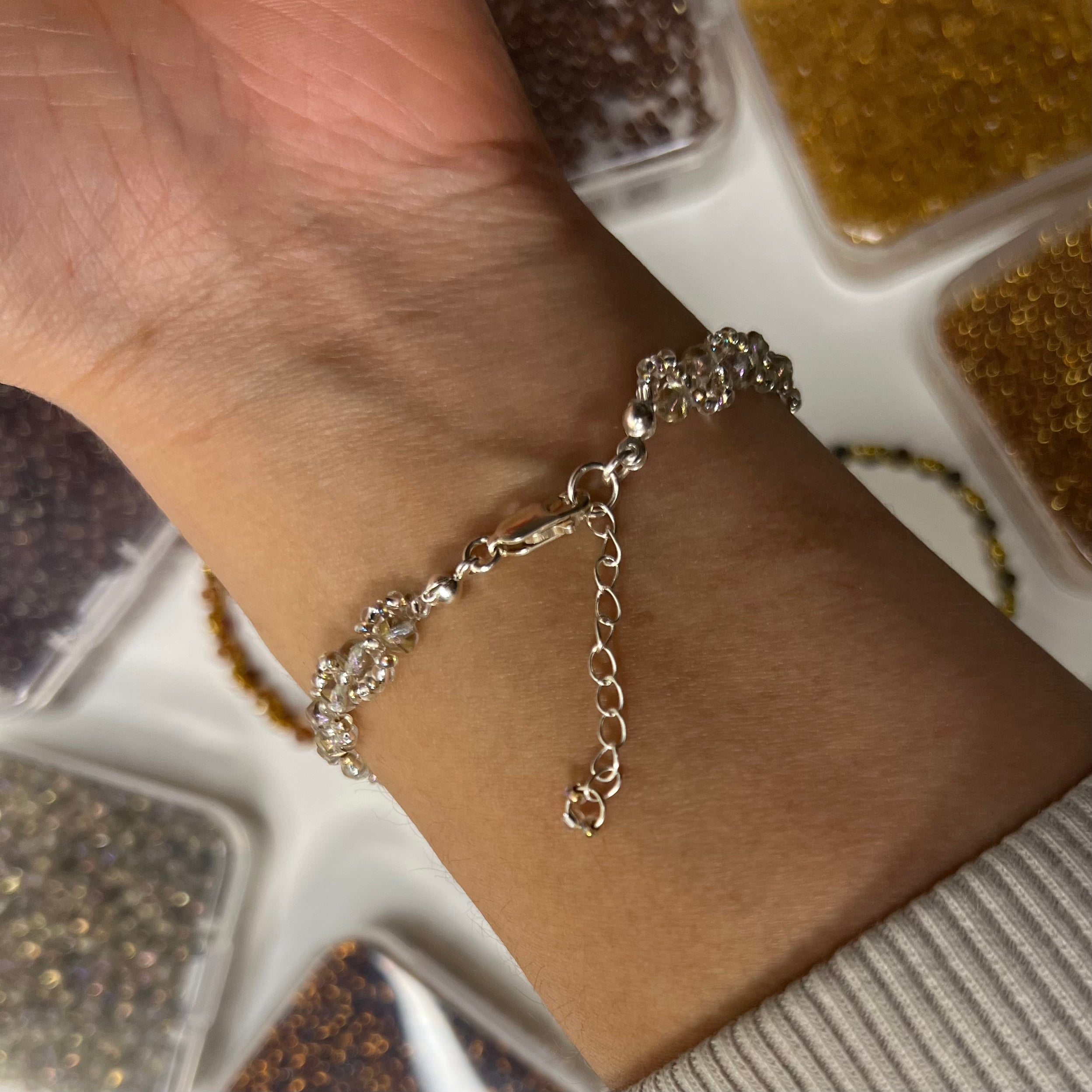 Silver bracelet on a wrist with a blurred background
