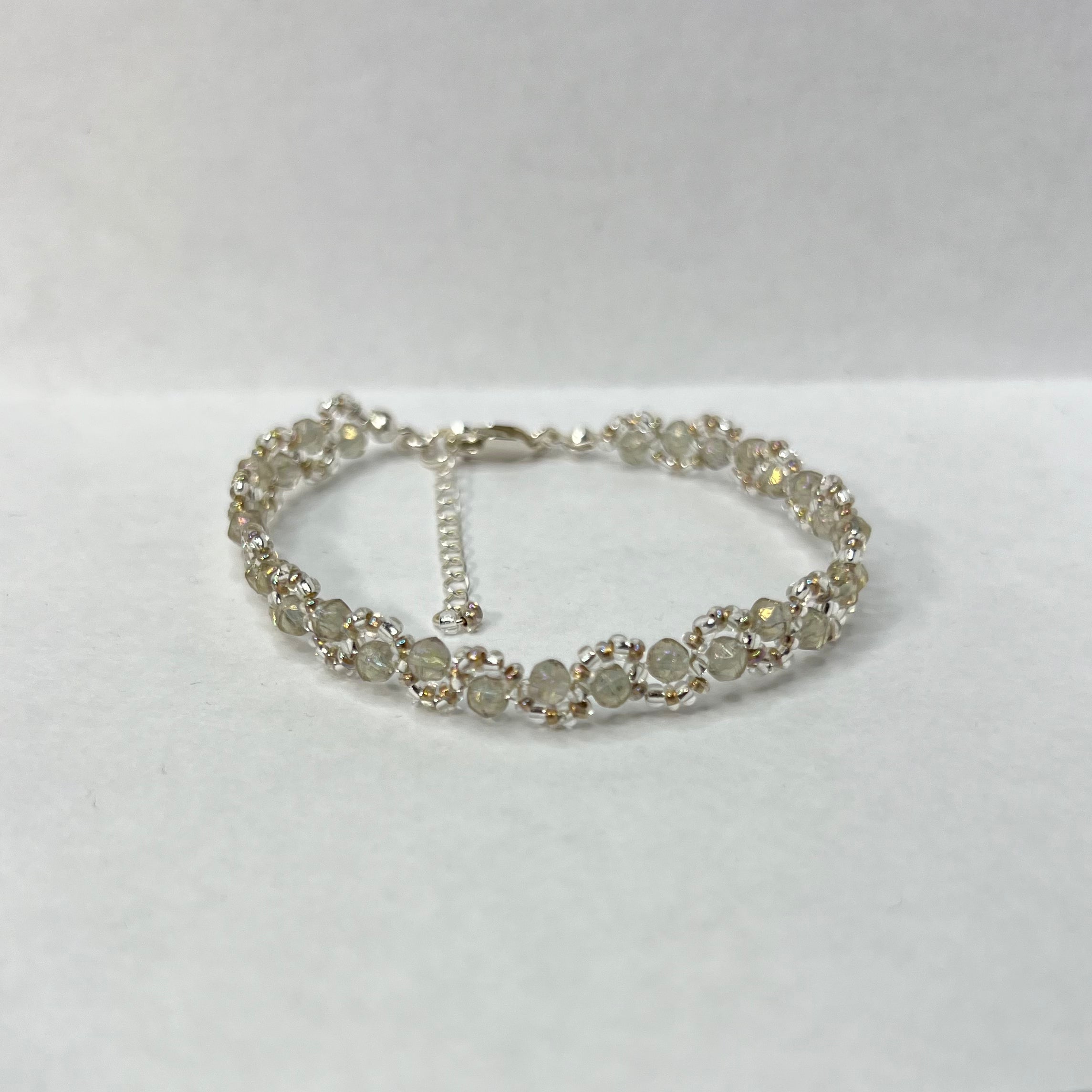 Silver bracelet with hazy gray beads on a white background