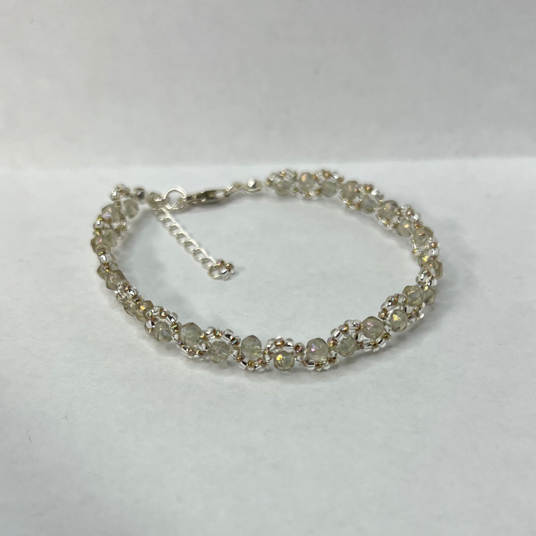 Silver bracelet with hazy gray beads on a white background