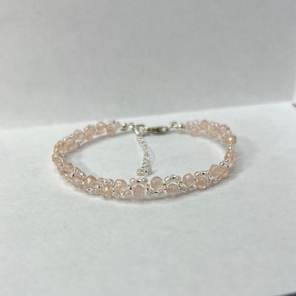 Baby pink and silver bracelet on a white background