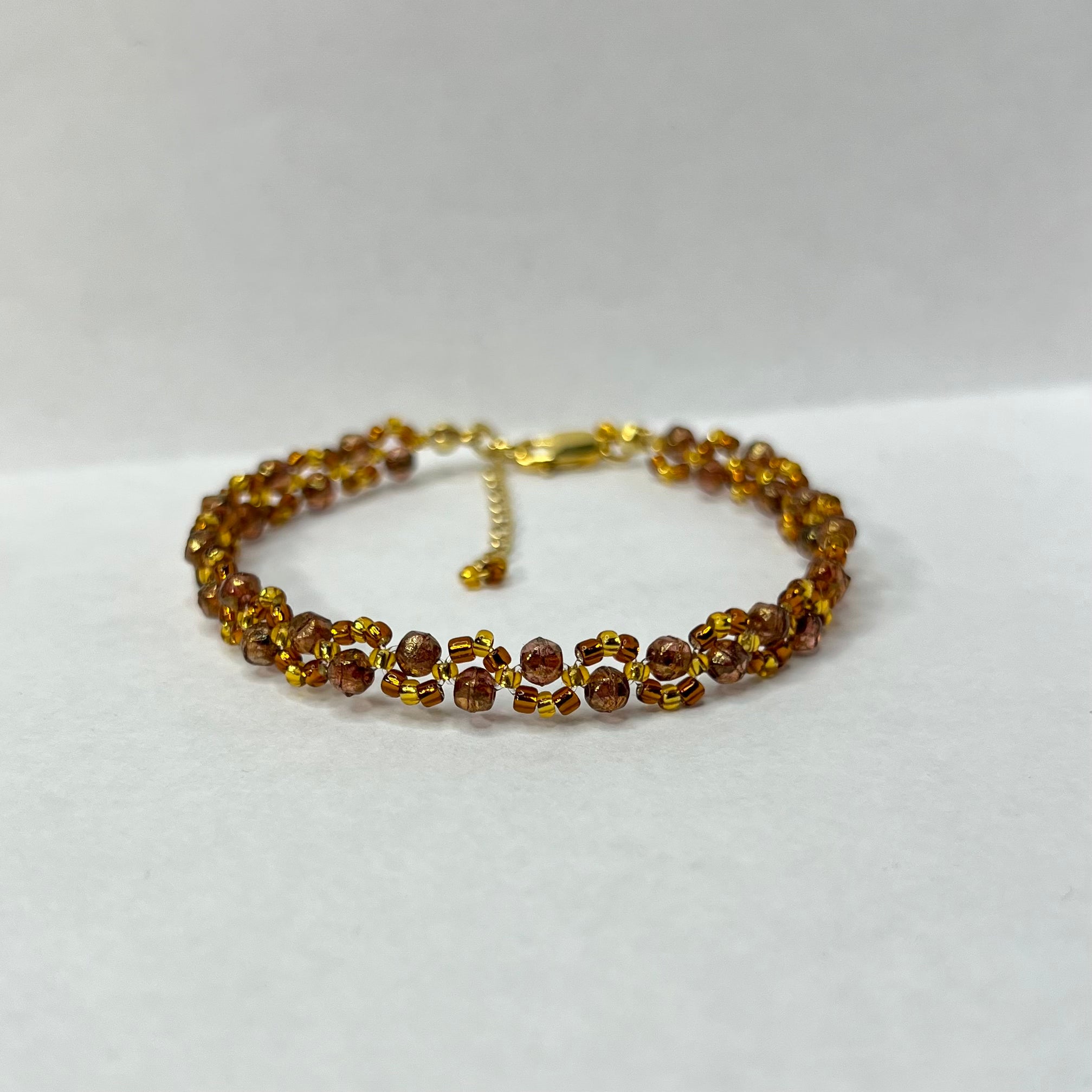 Beaded bracelet with gold accents on a white background