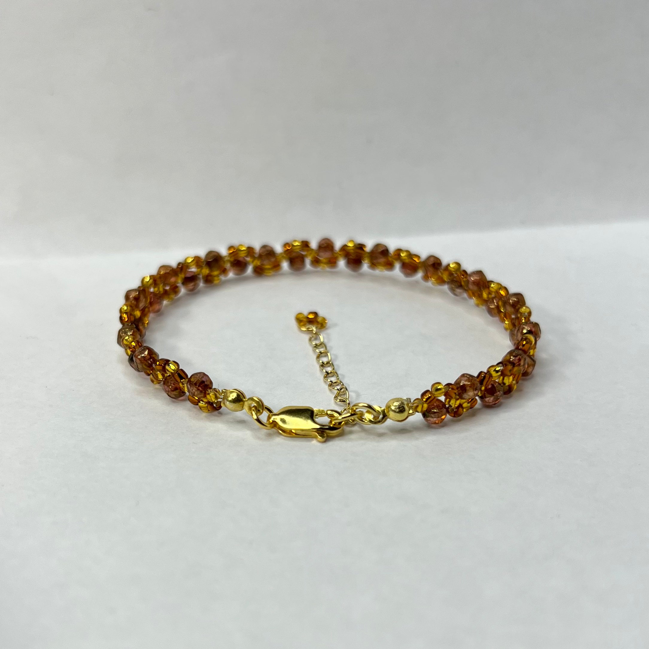Beaded bracelet with gold clasp on a white background