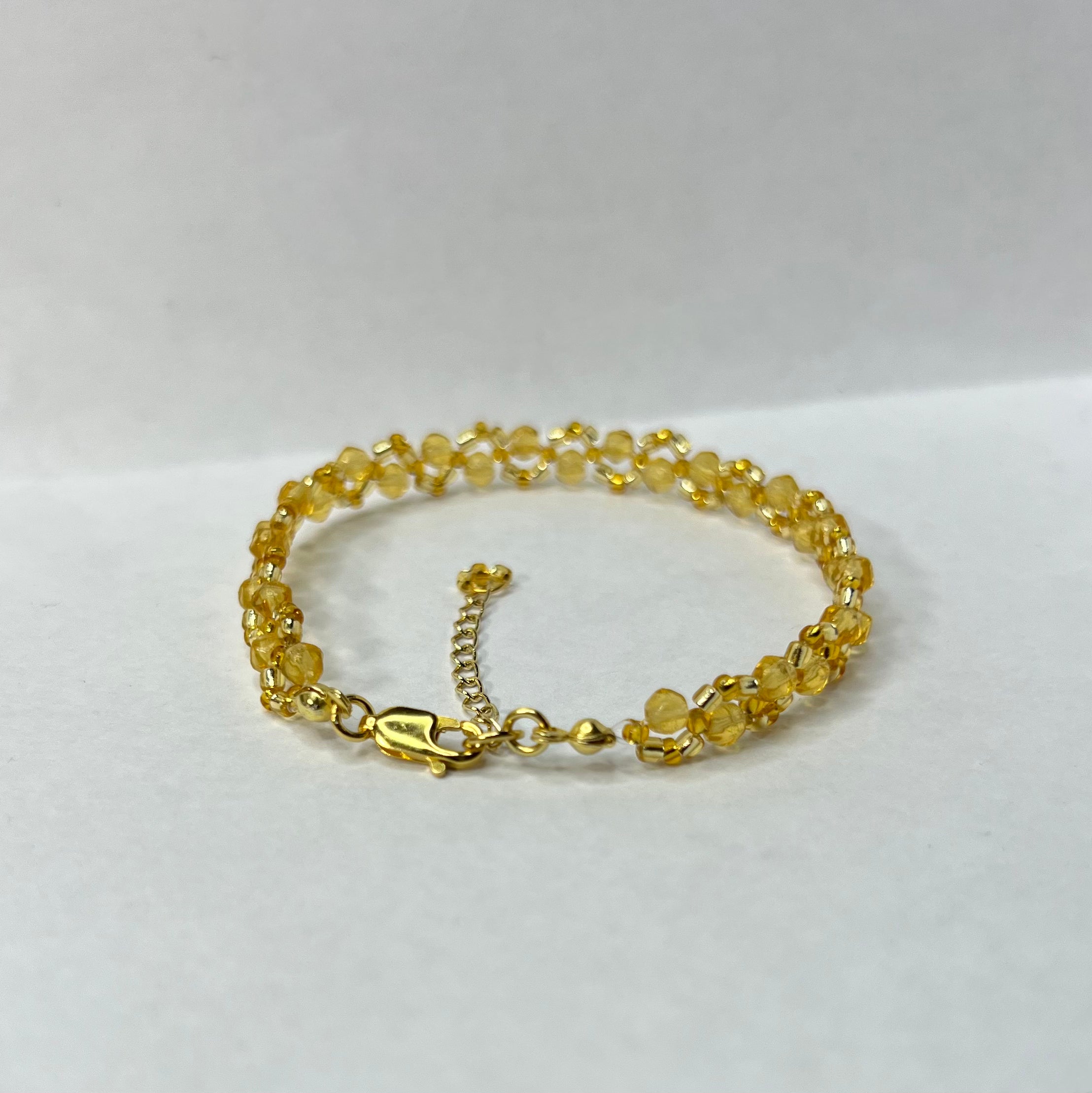 Gold bracelet on a white background