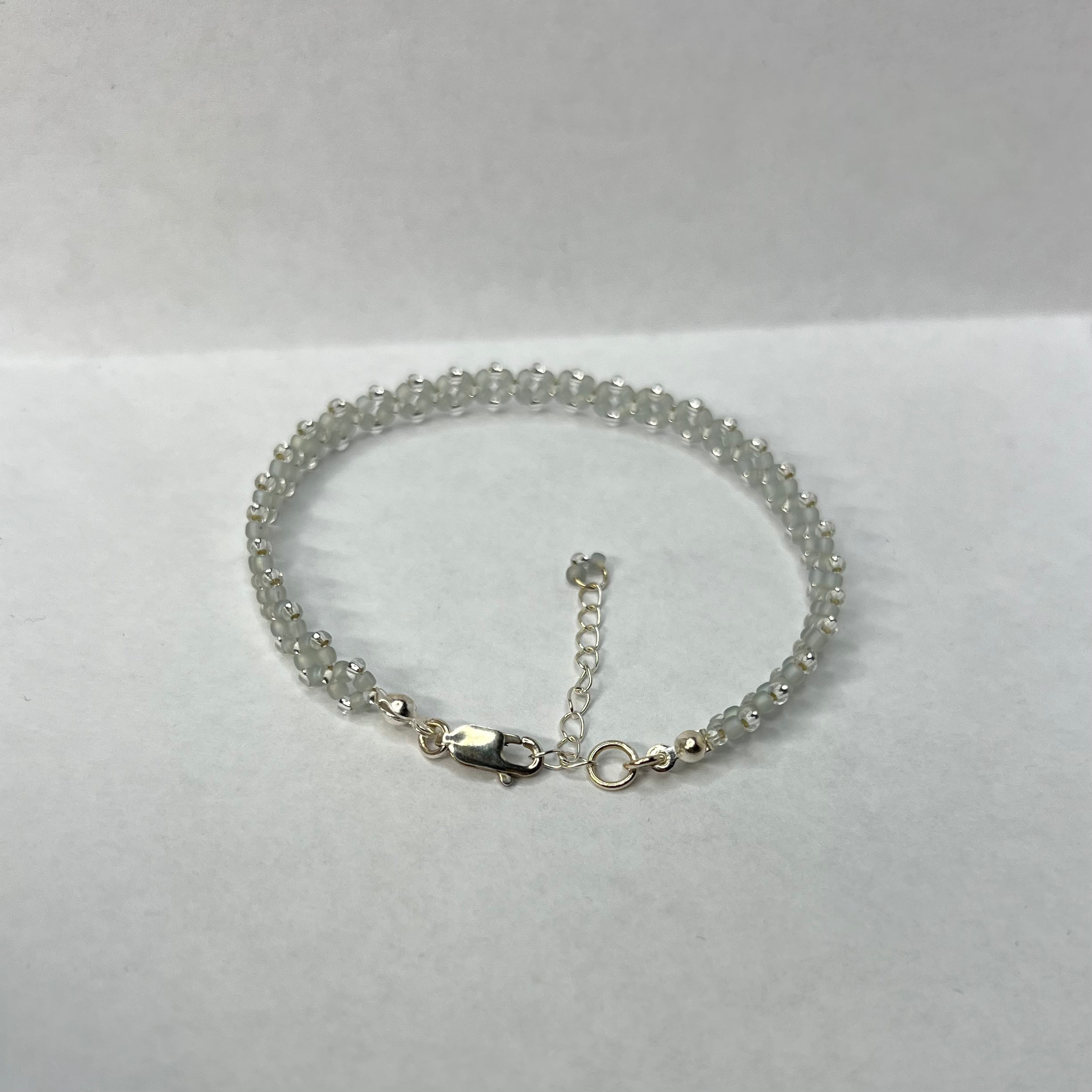 Silver beaded bracelet on a white background