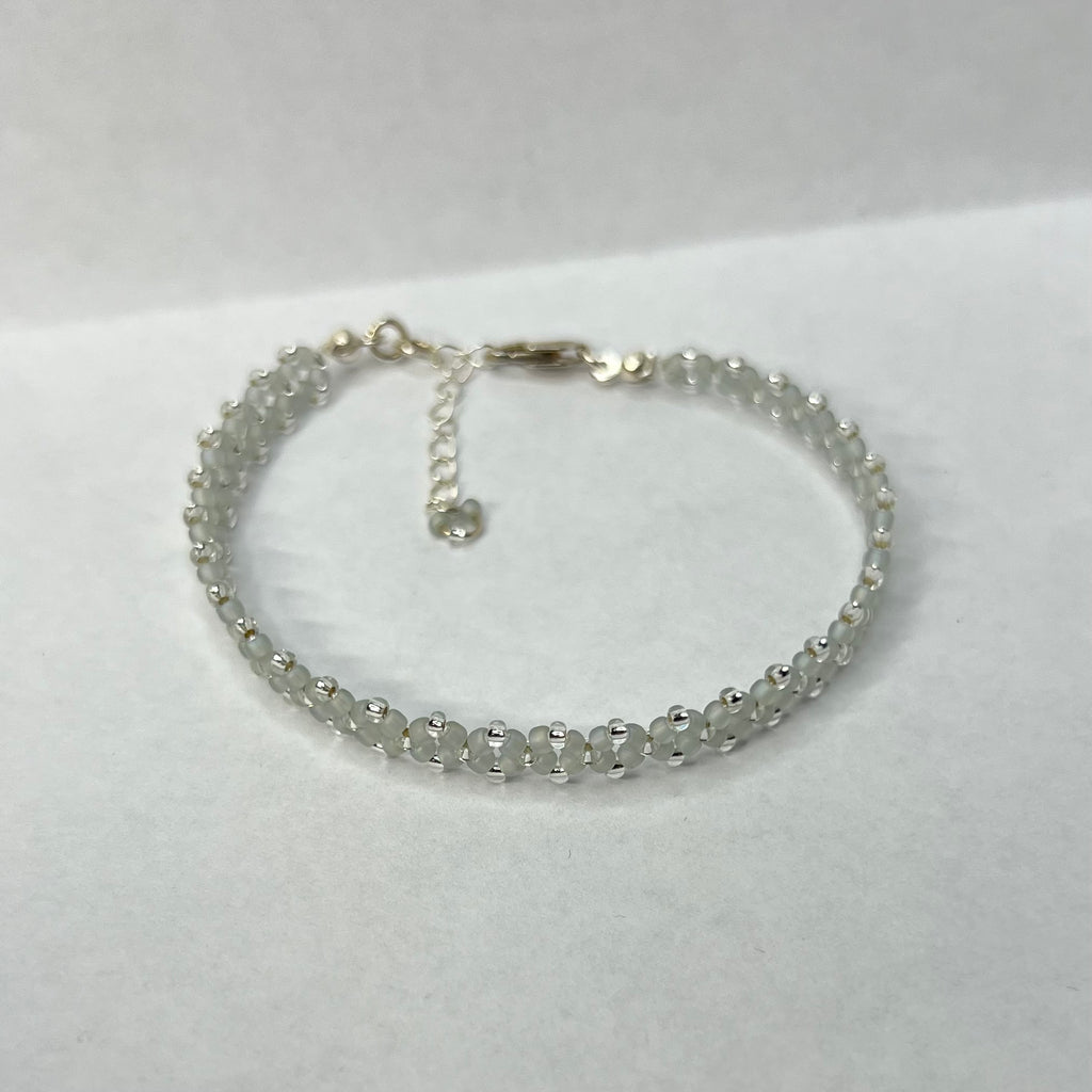 Silver beaded bracelet on a white background