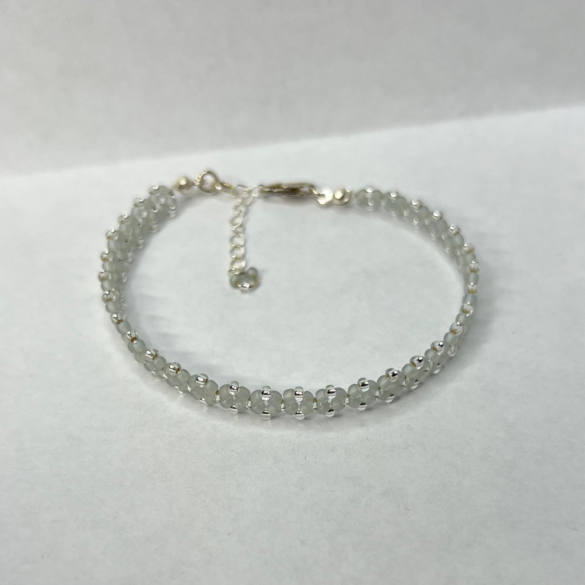 Silver beaded bracelet on a white background