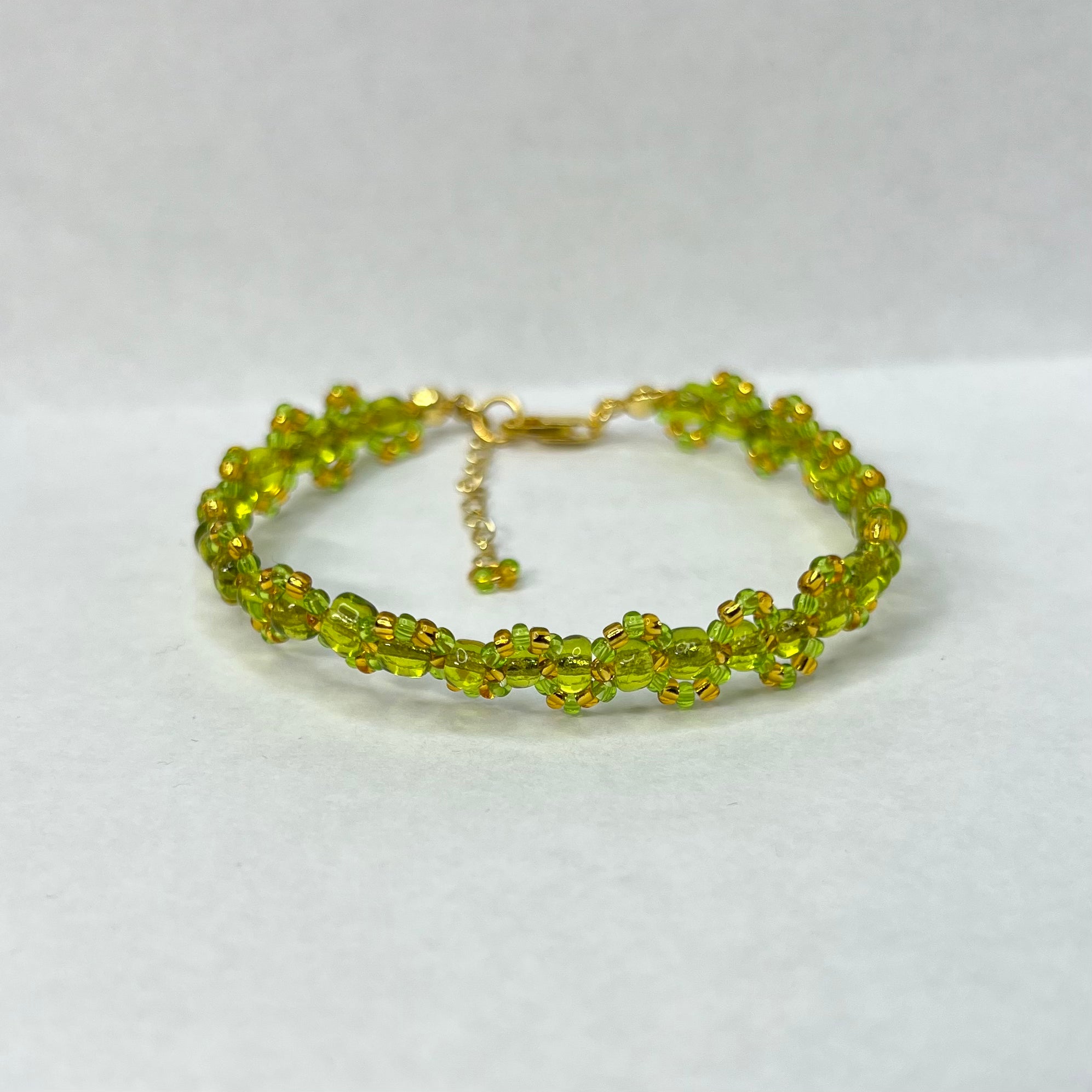 Green beaded bracelet on a white background