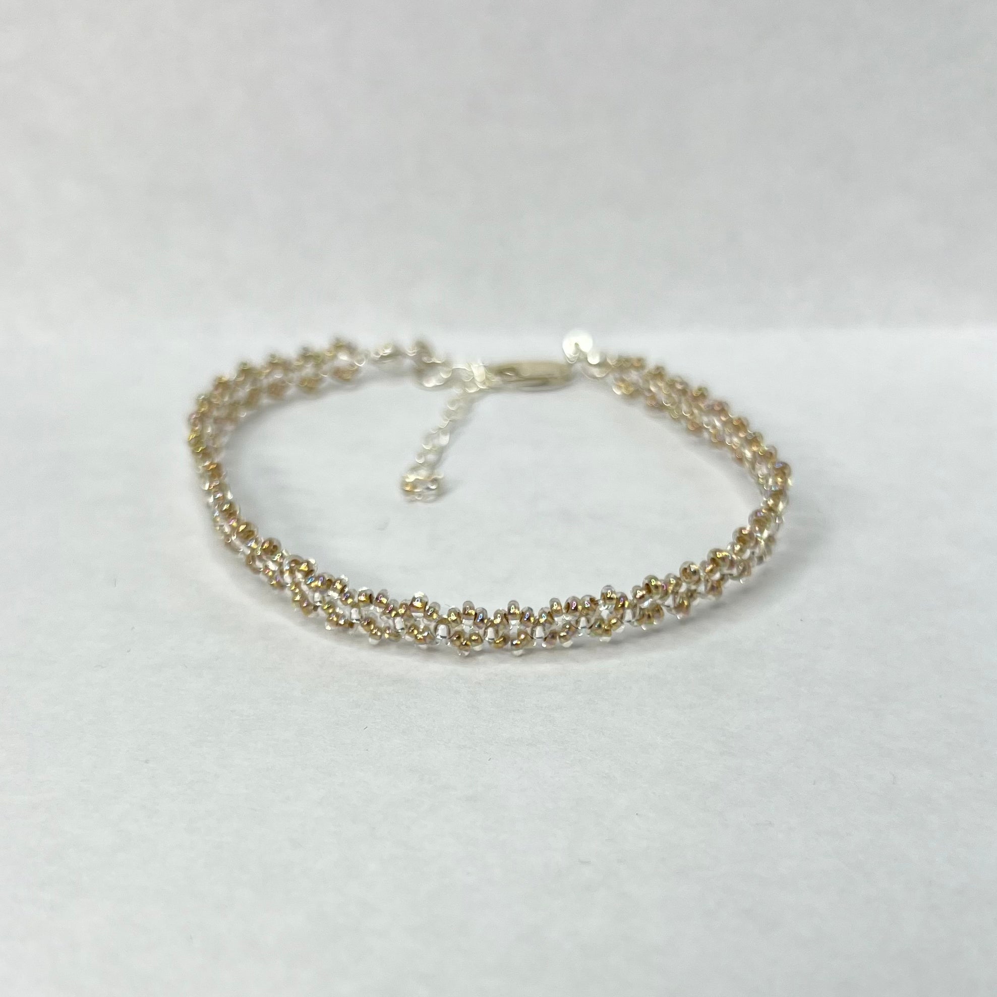 Silver bracelet on a light gray background