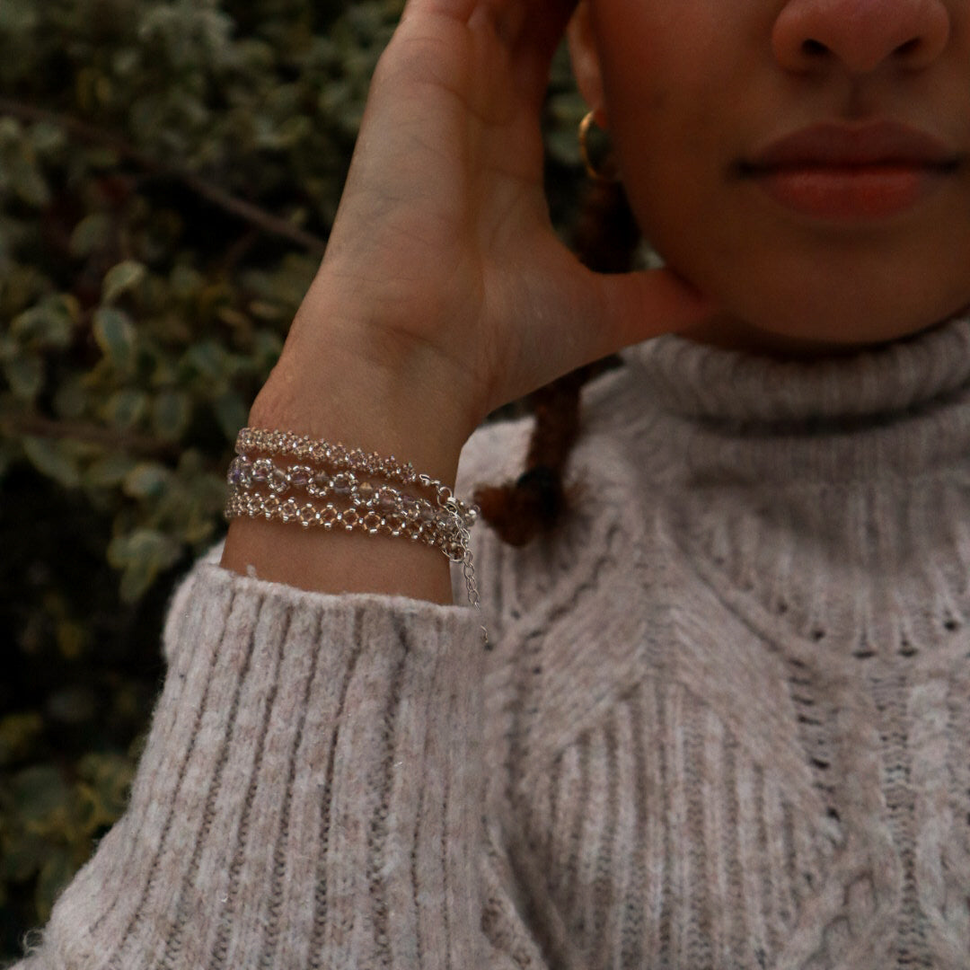 Person wearing a gray sweater with a blurred background