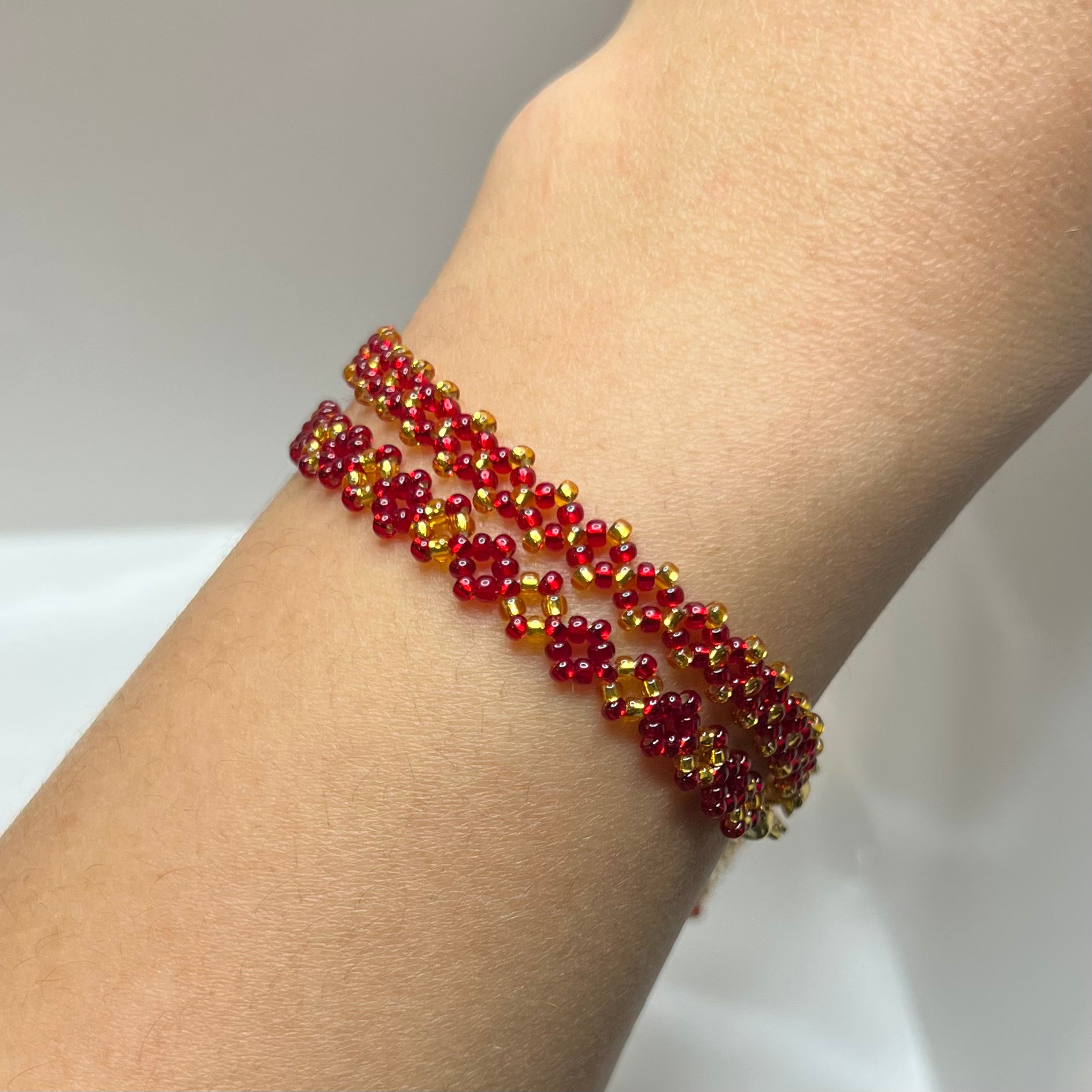 Beaded bracelet on a wrist against a neutral background