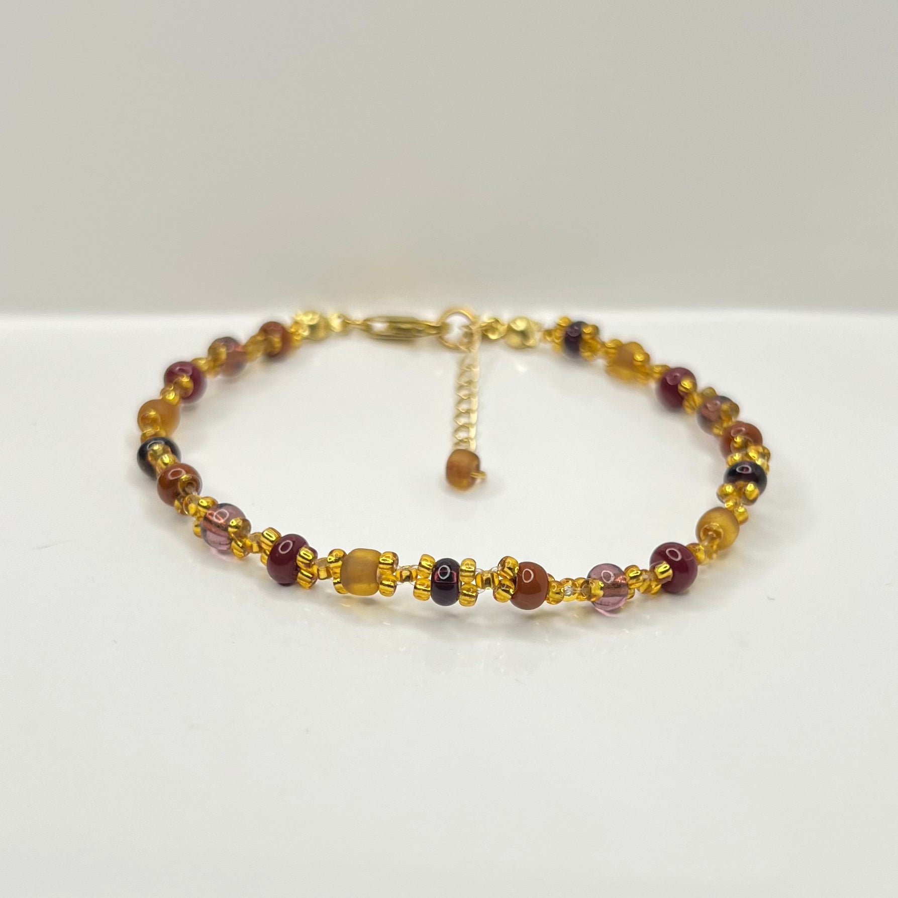 Beaded bracelet with gold accents on a white background