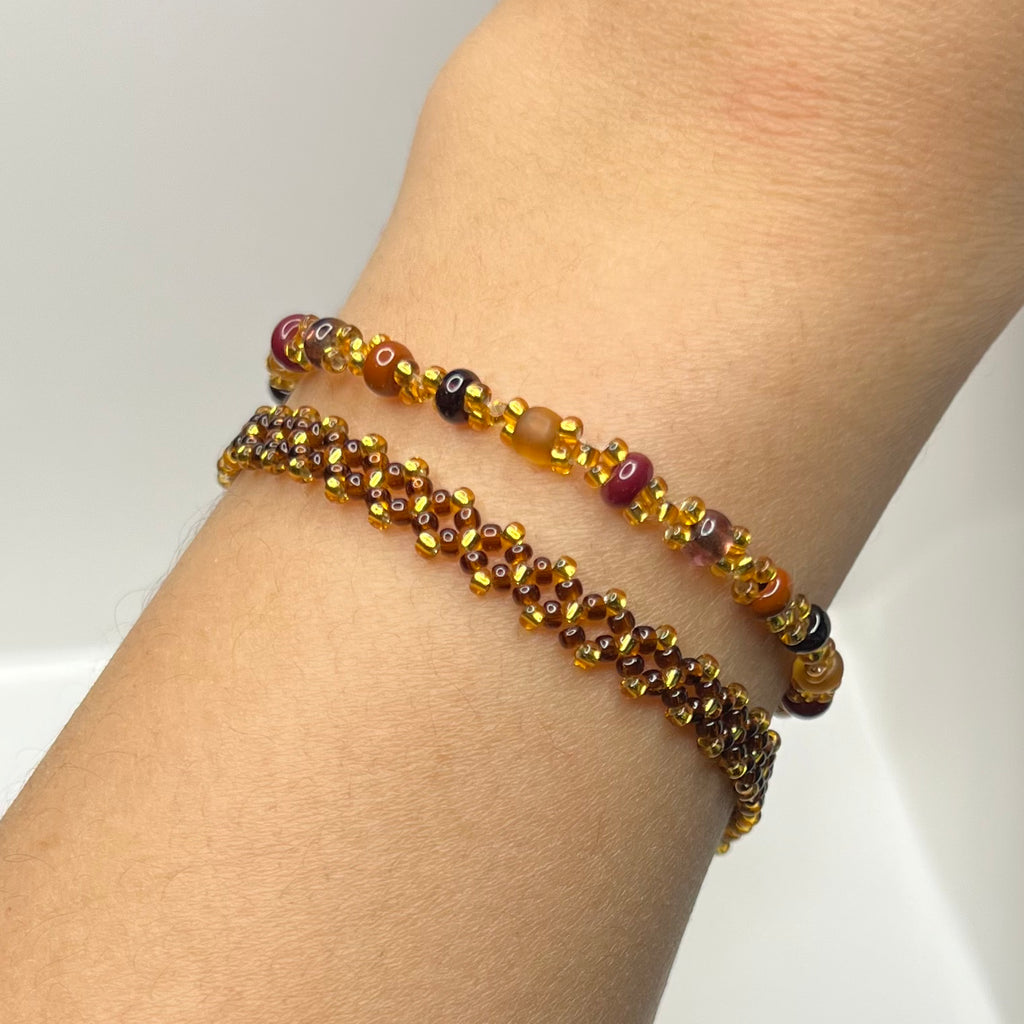 Beaded bracelet on a wrist against a neutral background