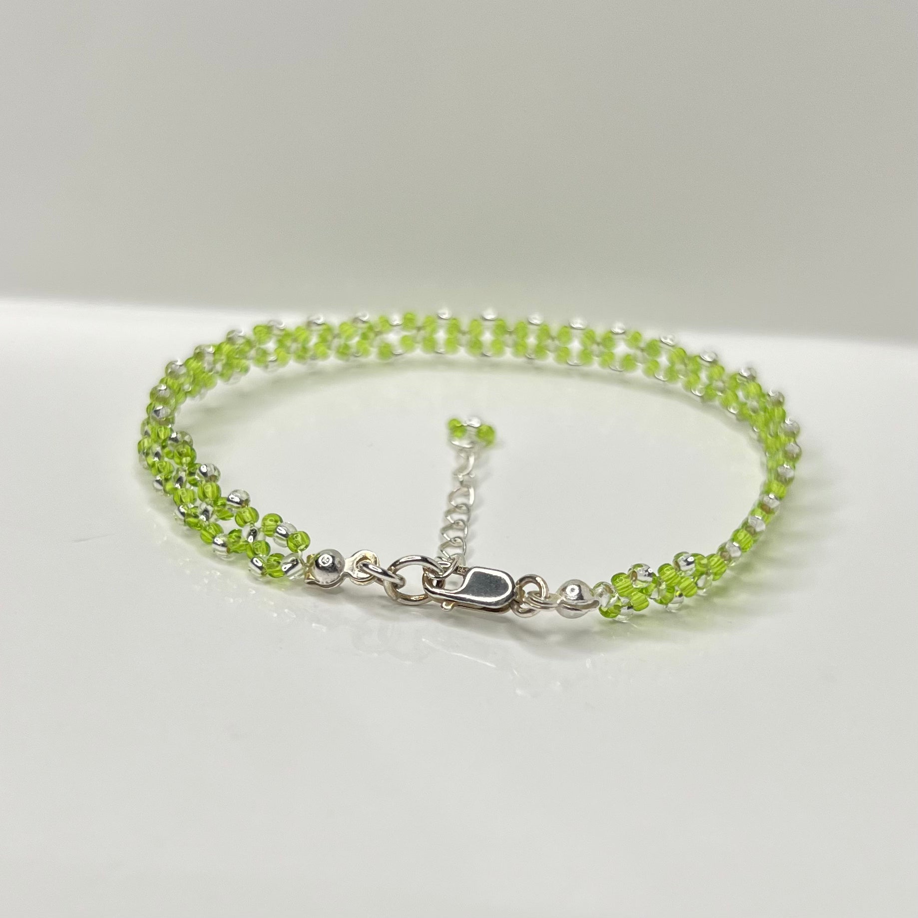 Green beaded bracelet on a white background