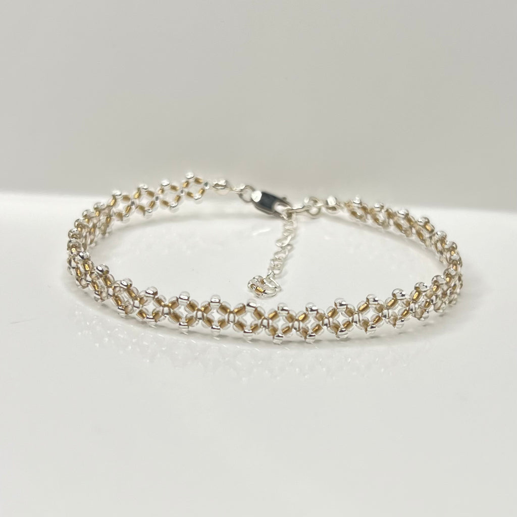Silver bracelet on a white surface