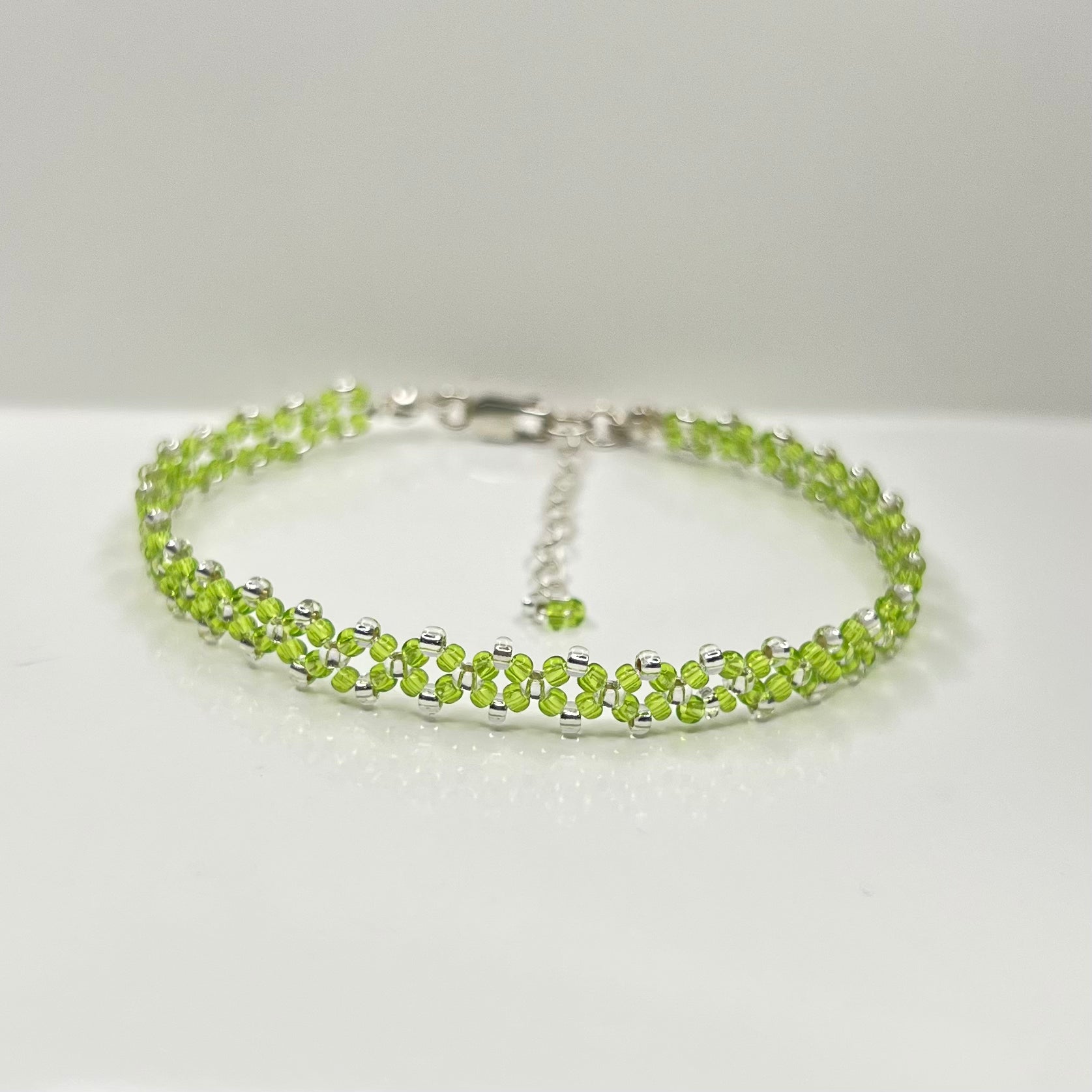 Green beaded bracelet on a white background